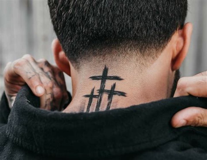 What does cross tattoo on neck mean?
